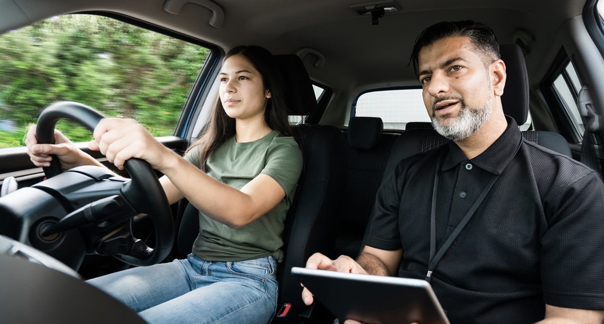 Learner driver receiving guidance from her instructor during a lesson
